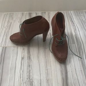 Cole Haan high heeled brown ankle booties.